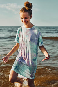 Girl spending a free time enjoying the sea and beach during summer vacation at sunset