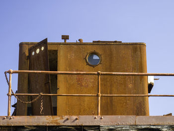 Low angle view of old abandoned building against clear sky