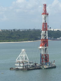 Industrial ship in sea against sky