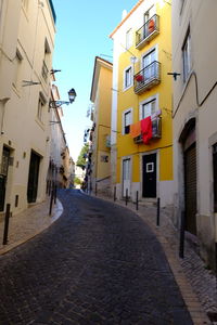 Street amidst buildings in city against sky