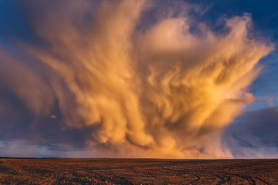 Scenic view of dramatic sky over land