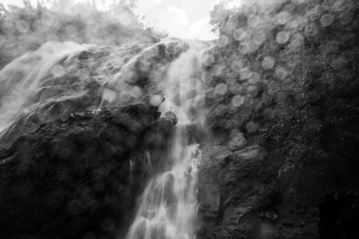 Low angle view of waterfall against sky