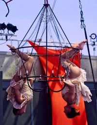 Close-up of clothes hanging on car against sky