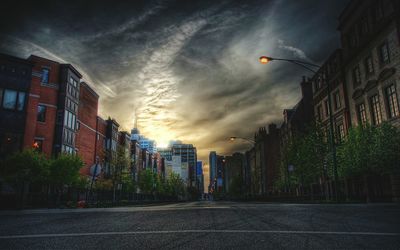 View of buildings against cloudy sky at sunset