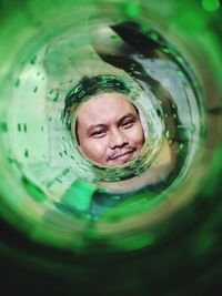 Portrait of a smiling woman swimming in glass