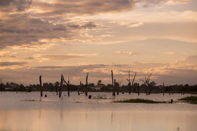 Scenic view of lake against sky during sunset