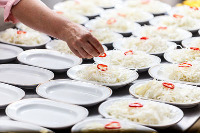 Cropped hand of man preparing food