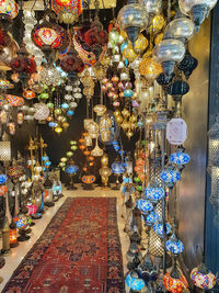 Illuminated lanterns hanging in store for sale