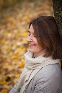 Portrait of smiling young woman during autumn