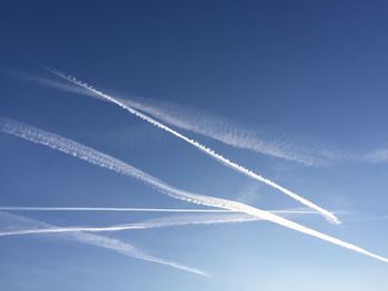 Low angle view of vapor trails against sky