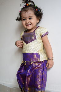 Portrait of smiling girl standing against wall