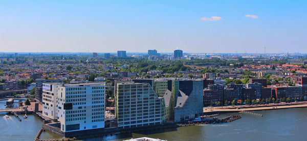 High angle view of river and buildings against clear sky