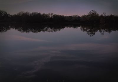 Scenic view of lake against sky at sunset