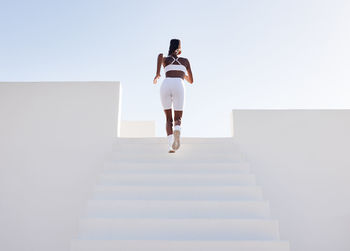 Full length of woman standing against white background