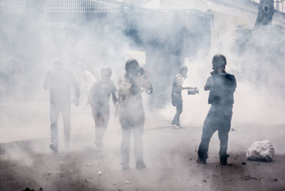Protestors standing in smoke