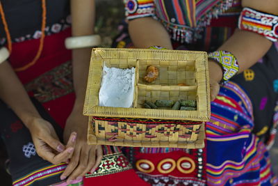 Flores girl using her traditional cloth holding a betel box for traditional activities 