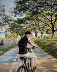 Man riding bicycle on road