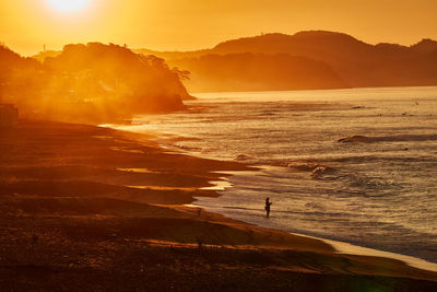 Scenic view of beach against sky during sunset