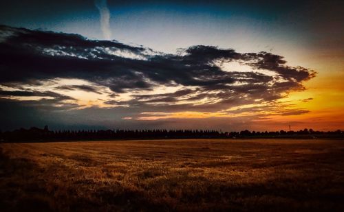 Scenic view of field against sky during sunset