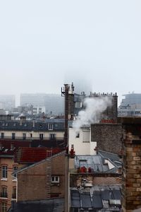 High angle view of smoke emitting from buildings against sky