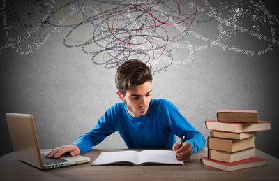 Young woman sitting on book