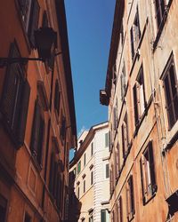 Low angle view of buildings against clear blue sky