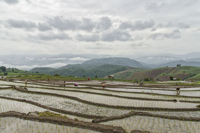 Scenic view of mountains against cloudy sky