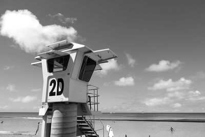 Lifeguard hut on beach against sky