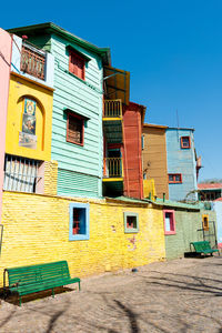 Low angle view of multi colored houses against clear sky