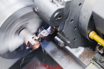 Close-up of turning work on a machine, turning a metal workpiece. motion blur