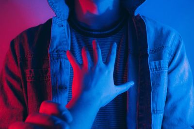 Midsection of man with blue hair