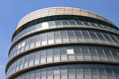 Low angle view of modern building against clear blue sky