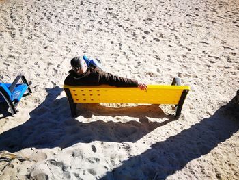 High angle view of yellow toy on sand