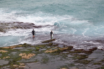 People on beach by sea