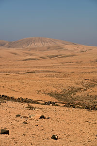 Scenic view of desert against clear sky