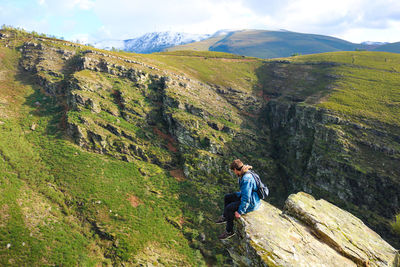 Full length of man standing on mountain against sky