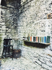 Empty chairs against wall in old building