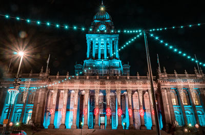 Low angle view of illuminated building at night