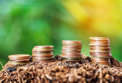 Close-up of stacked coins outdoors