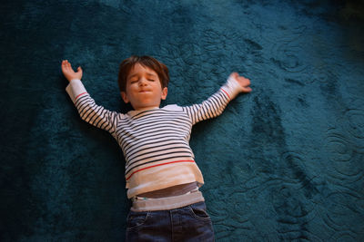 High angle view of boy playing carpet at home