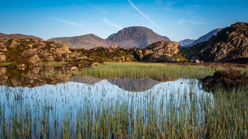 The evening light on the lakeland mountain of great gable reflecting in innominate tarn