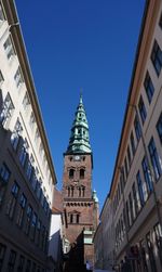 Low angle view of buildings against clear blue sky
