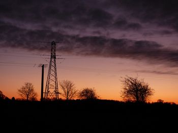 Low angle view of silhouette trees against sky during sunset