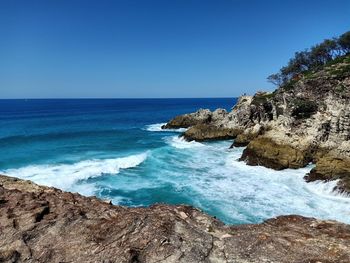 Scenic view of sea against clear blue sky