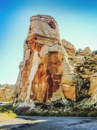 Low angle view of rock formation against sky