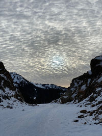 Scenic view of snow covered mountains against sky during sunset