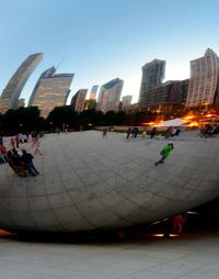 Group of people in city against buildings