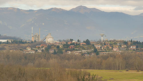 View of townscape by mountain against sky