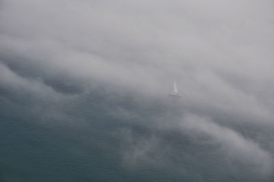 Low angle view of sailboat in sea against sky