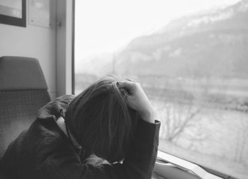 Close-up of young woman traveling in train